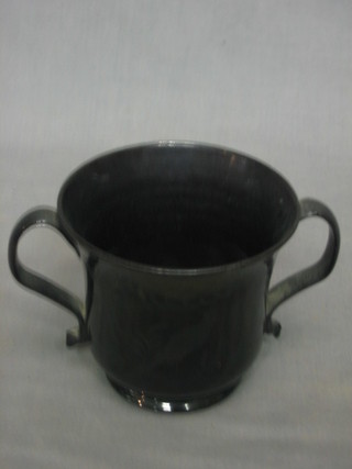 An 18th/19th Century black glazed twin handled cup decorated a bird amidst branches 4"