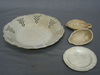 A circular ribbonware stoneware plate 8" (f and r), a small plate 3", a leaf shaped spoon 4" and a white mould in the form of a bird 3"