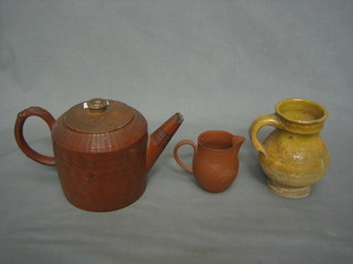 An 18th/19th Century circular Tanware teapot 4", a pottery jug 5" and a Tanware jug 3" (f and chipped)