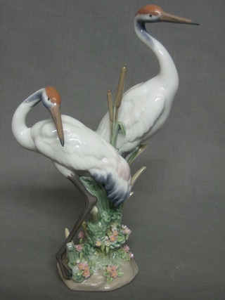 A Lladro figure of 2 standing storks amidst reeds, the base marked 1611, 11"