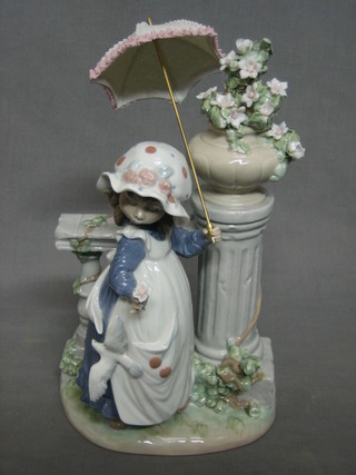 A Lladro figure of a standing girl by a balustrade with parasol, base marked D-5MY, 11"
