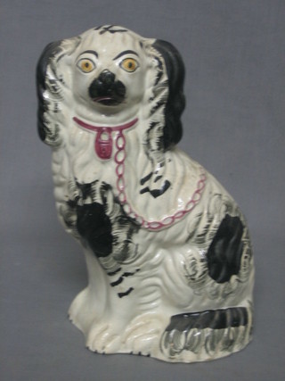 A 19th Century Staffordshire figure of a black and white seated Spaniel 10"