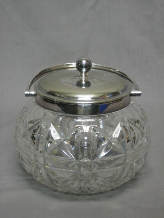 A circular cut glass biscuit barrel with silver plated mounts 6"
