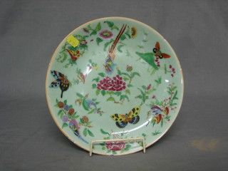 An Oriental green glazed plate decorated birds and butterflies, 10" (some chips)