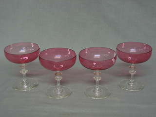 A set of 6 pink tinted glass champagne saucers with clear glass stems