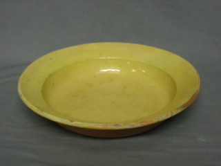 A circular yellow glazed bowl 12" and a brown glazed bowl 12"