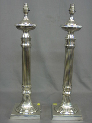 A pair of large and impressive reeded silver plated table lamps 23"