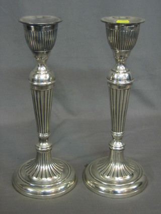 A pair of reeded silver plated candlesticks 14"