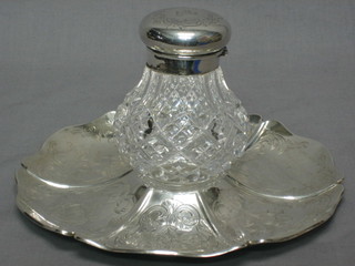 A circular cut glass inkwell, raised on an engraved silver stand with presentation inscription, London 1857