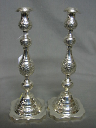 A pair of Victorian embossed silver candlesticks with detachable sconces and engraved decoration London 1861, 8 ozs