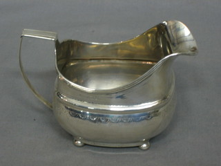 A George III silver cream jug raised on 3 bun feet, with engraved decoration London 1808, marks rubbed, 4 ozs