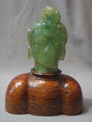 A carved "jade" portrait bust of a Deity, raised on a carved hardwood shoulders (bust f and r) 7 1/2"