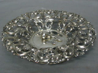 A circular pierced Continental silver basket, the centre decorated a pomegranate, raised on a circular spreading foot 7 ozs