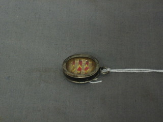 An oval locket containing a relic -  a fragment from the bones of St. Peter Apostle, from the bones of St. Thomas Aquinas, from the Bones of St. Edward King, and from the bones of St. Aloysius Gonzaga