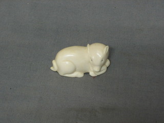 A carved ivory Netsuke in the form of a seated pig  1 1/2"