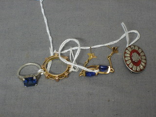 A white gold ring set a square blue stone, a pair of earrings, a gold brooch and an enamelled brooch 