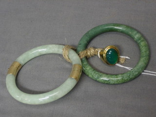 A gold dress ring set a "jade" cabouchon stone and 2 jade coloured bangles