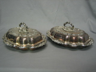 A pair of oval silver plated entree dishes and covers
