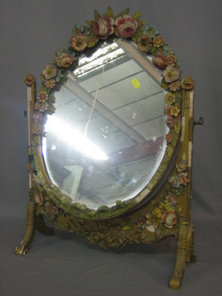 An oval bevelled plate dressing table mirror contained in a Barbola mounted frame 19"