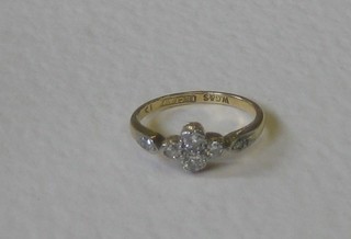 A lady's gold dress ring set 4 diamonds to the centre and 2 to the shoulders