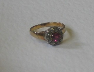 An lady's Edwardian gold ring set a ruby surrounded by diamonds 