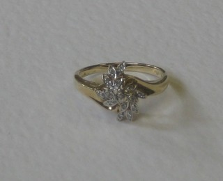 A lady's 9ct yellow gold dress ring of floral design set diamonds