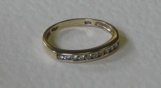 A lady's gold half eternity ring set diamonds