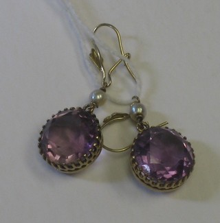 A pair of gold and amethyst drop earrings