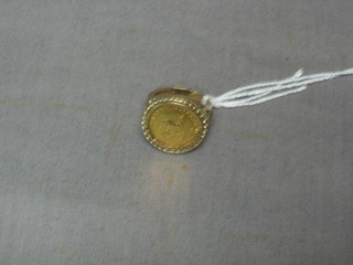 A gold ring set a 1985 1/10 Krugerrand