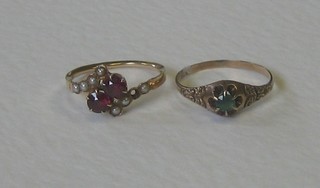 A gold dress ring set 2 red coloured stones supported by pearls (1 pearl missing) and a gold dress ring set a green stone