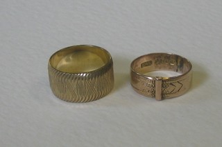 A 9ct gold buckle ring and a 9ct gold wedding band