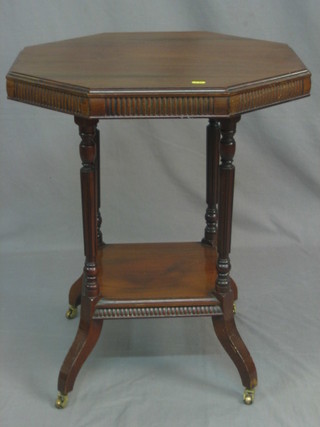 A Victorian walnut octagonal occasional table raised on turned supports with undertier 24"