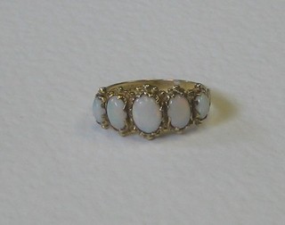 A gold dress ring set 5 graduated oval cut opals