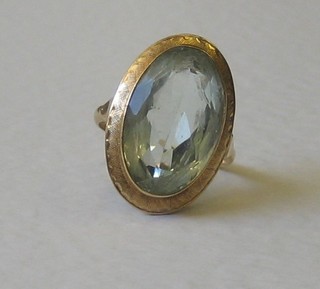 A gold dress ring set an oval aquamarine