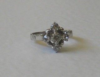A white gold cross shaped dress ring set diamonds