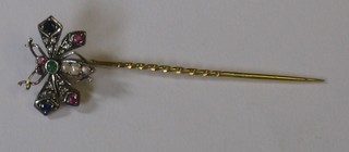 A butterfly stick pin set semi-precious stones