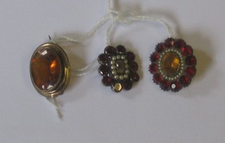 A gilt metal mourning brooch and 2 other brooches