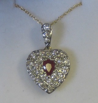 A gold heart shaped pendant set rubies and diamonds