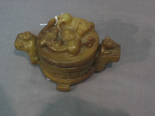 An Eastern jade coloured carved jar and cover with handles 2"