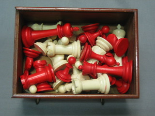 A carved red and white ivory Staunton chess set