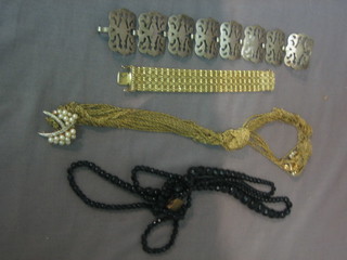A silver plated bracelet, a gold plated bracelet, a gold plated necklace and a string of jet beads