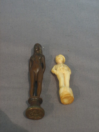 A carved ivory pipe tamper in the form of a sailor? (head f and r) 3" and a bronze seal in the form of a naked lady 3 1/2"