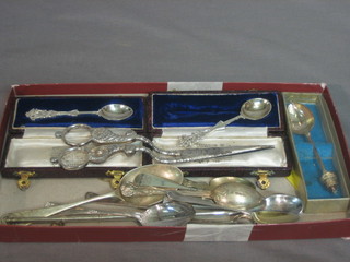A pair of silver plated grape scissors, a silver spoon decorated a Swastika, 3 silver teaspoons and etc