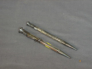 A silver propelling pencil and 1 other