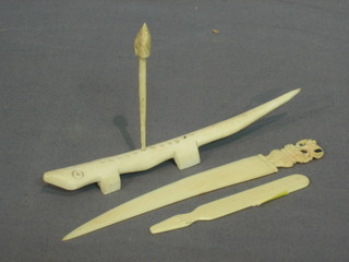 An ivory paper knife 6 1/2", an ivory tooth pick holder in the form of a crocodile and a plastic manicure implement