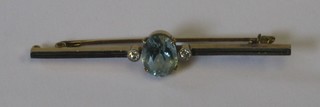 A 15ct gold bar brooch set an aquamarine and supported by 2 diamonds