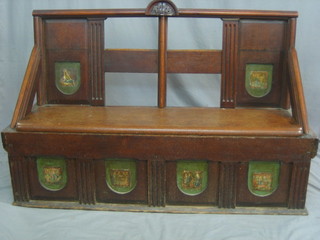 A Victorian mahogany settle with panelled decoration depicting religious figures, the seat with hinged lid, 53"