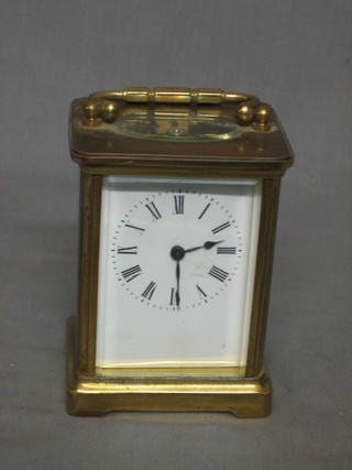 A 19th Century French 8 day carriage clock with enamelled dial and Roman numerals (slight crack to dial) contained in a gilt metal case