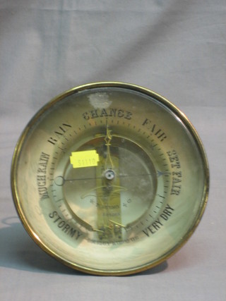 An aneroid barometer contained in a gilt metal case by W T Hendry & Co
