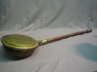 An 18th/19th Century brass warming pan with turned fruitwood handle